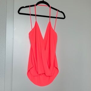 Bright coral size medium halter top. It crosses in the front.